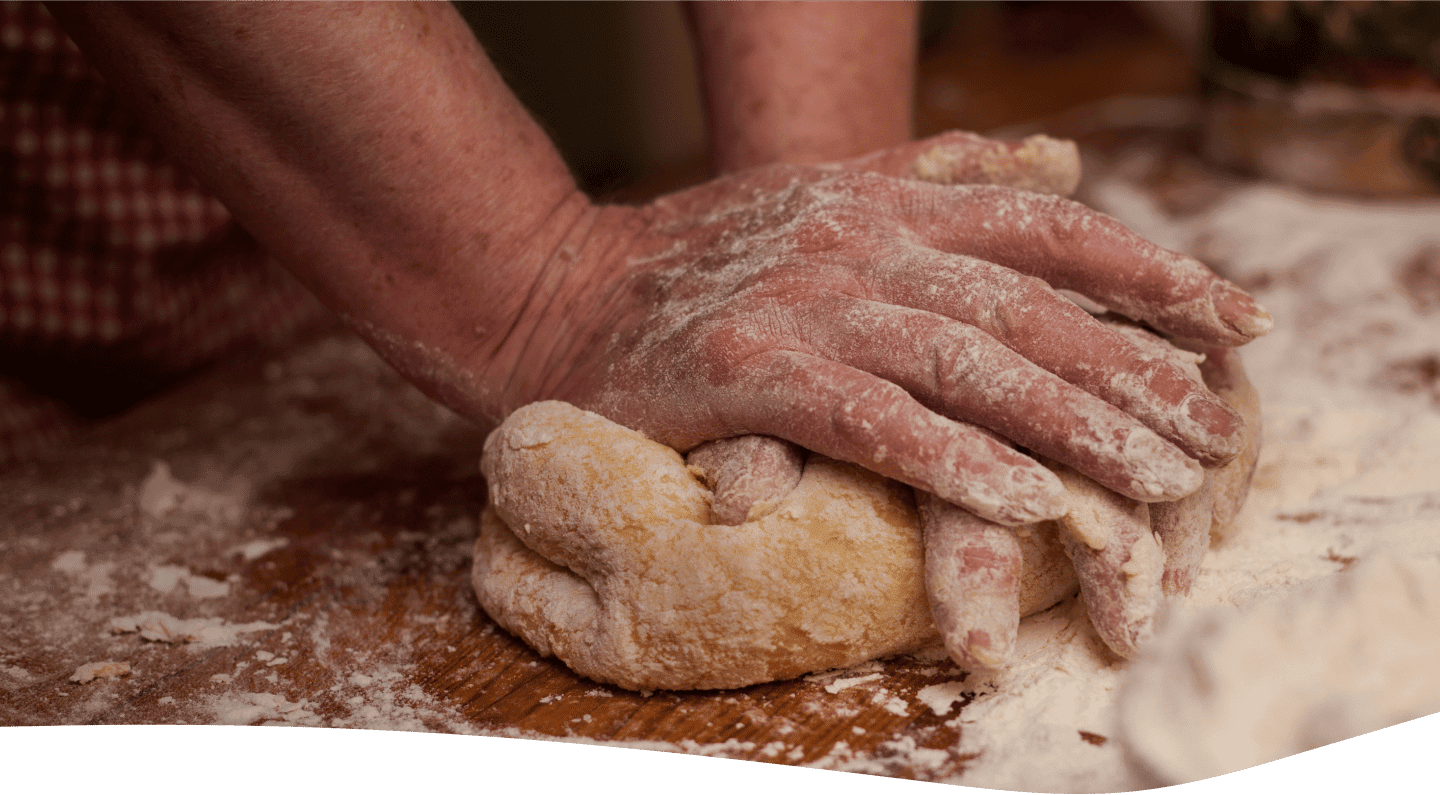A person kneading dough